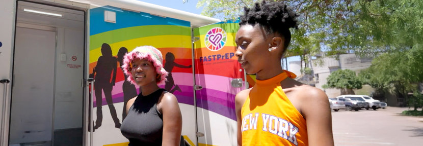 Two women outside of mobile clinic