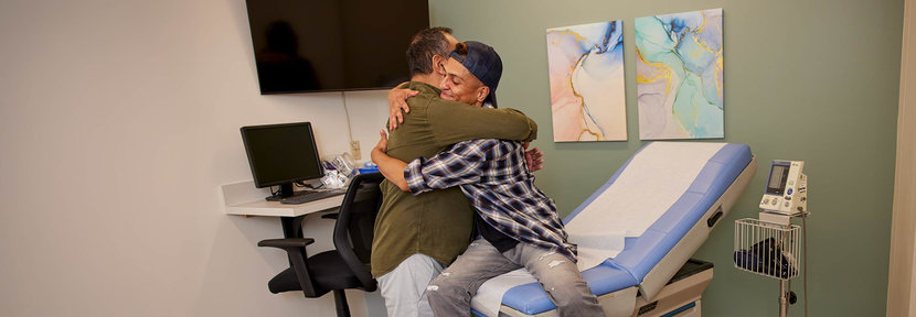 Patient hugging father in a Doctors office