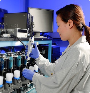 Scientist utilizing Cepheid lab in a cartridge test.