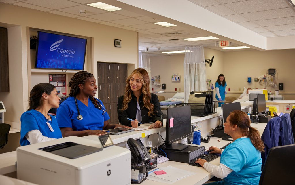 Clinical staff collaborating at a hospital nurses’ station