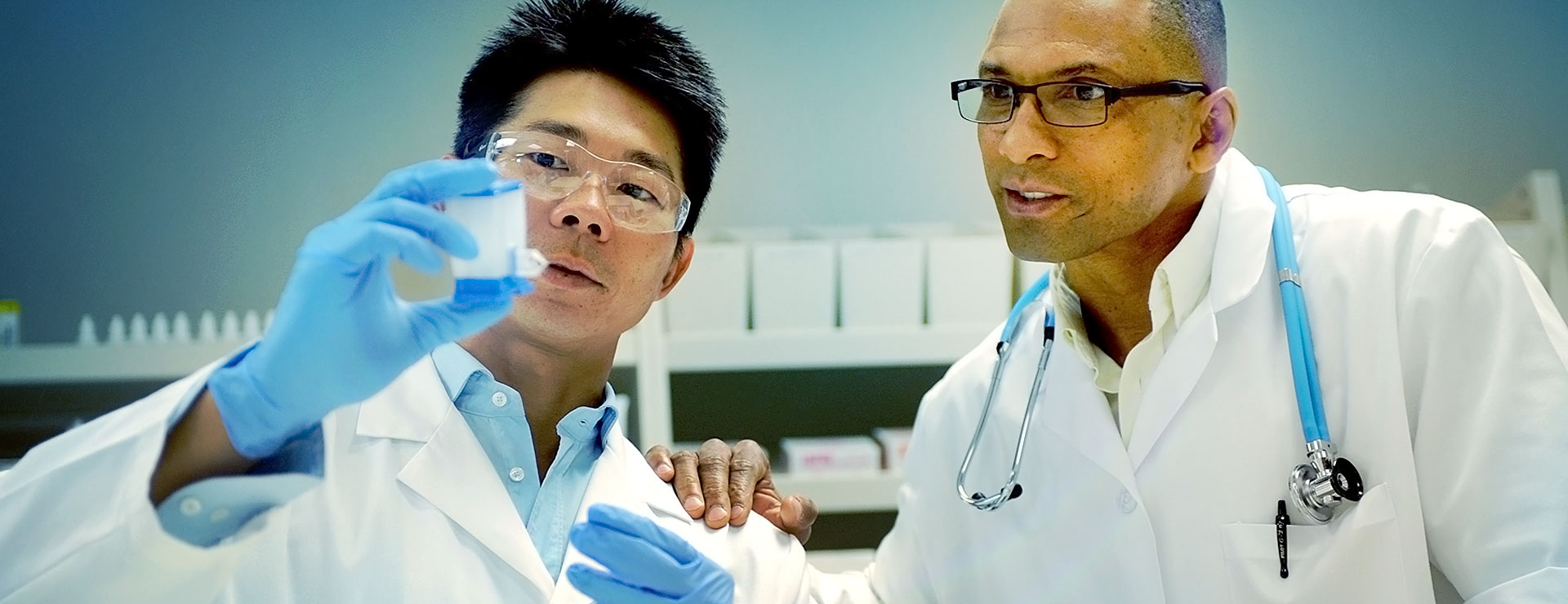 Scientists inspect a PCR test cartridge