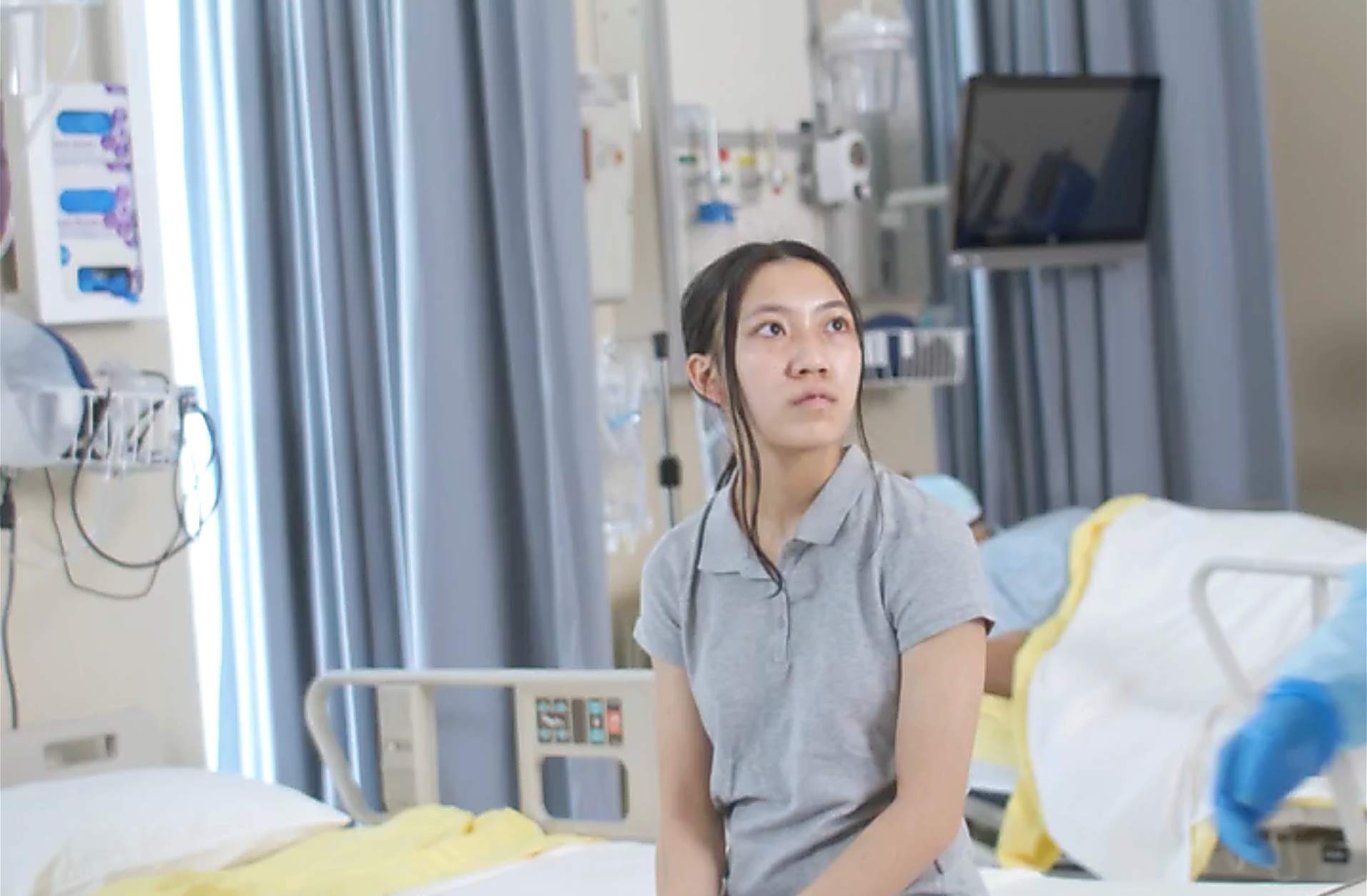 An ill woman on a hospital bed